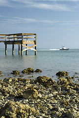 Image showing pier rocky shoreline with boat