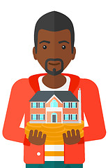 Image showing Man holding house model.