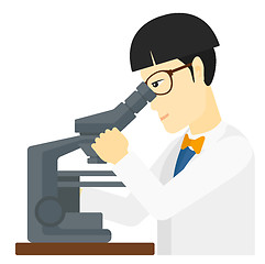 Image showing Laboratory assistant with microscope.