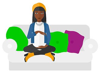 Image showing Pregnant woman sitting on sofa.