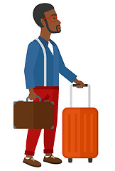 Image showing Man with suitcase on wheels and briefcase.