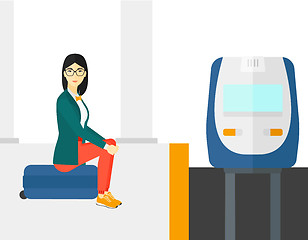 Image showing Woman sitting on railway platform.