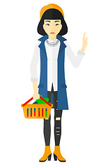 Image showing Woman holding supermarket basket.