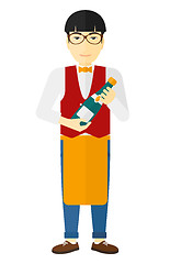 Image showing Waiter holding bottle of wine.