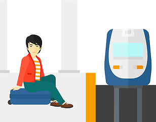 Image showing Man sitting on railway platform.