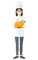 Image showing Woman holding roasted chicken.