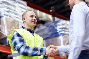 Image showing worker and businessmen with clipboard at warehouse