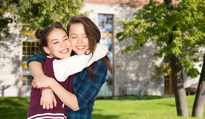 Image showing happy smiling pretty teenage student girls hugging