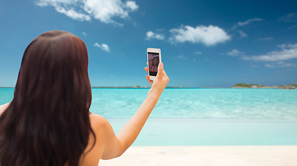 Image showing young woman taking selfie with smartphone