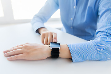 Image showing close up of hands setting smart watch