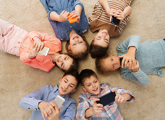 Image showing happy smiling children lying on floor in circle