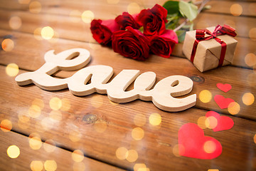 Image showing close up of gift, word love, red roses and hearts