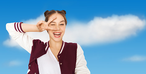 Image showing happy smiling teenage girl showing peace sign