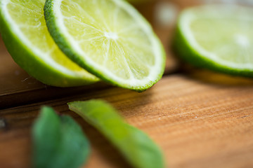 Image showing lime slices on wooden table