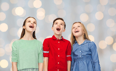 Image showing amazed boy and girls looking up