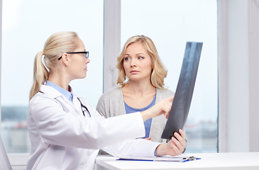 Image showing woman patient and doctor with spine x-ray scan