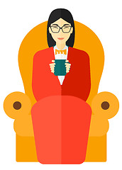 Image showing Woman sitting in chair with cup of tea.