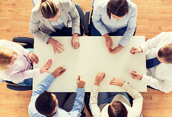 Image showing close up of business team sitting at table