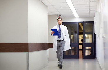 Image showing doctor with clipboard walking along hospital