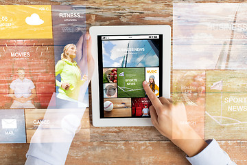 Image showing close up of hands with news app on tablet pc
