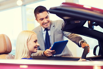 Image showing happy woman with car dealer in auto show or salon