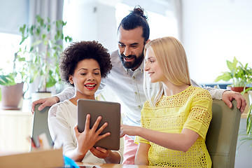 Image showing happy creative team with tablet pc in office