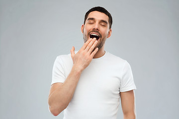 Image showing yawning man over gray background