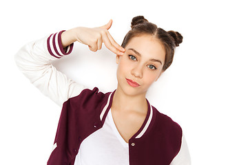 Image showing bored teenage girl making finger gun gesture