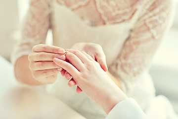 Image showing close up of lesbian couple hands with wedding ring
