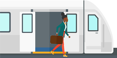 Image showing Woman going out of train.