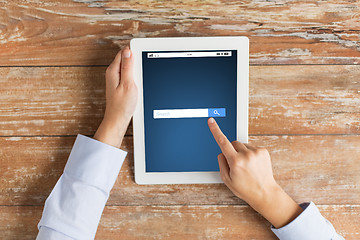 Image showing close up of hand with internet search on tablet pc