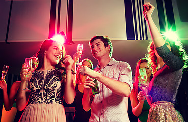 Image showing smiling friends with wine glasses and beer in club