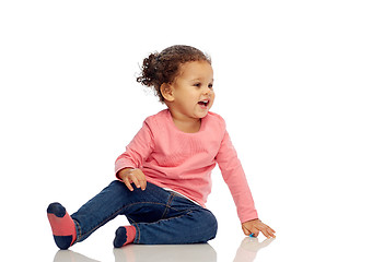 Image showing smiling little baby girl sitting on floor