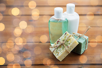 Image showing close up of handmade soap bars and lotions on wood