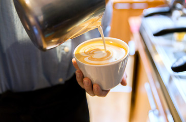 Image showing close up of woman making coffee at shop or cafe