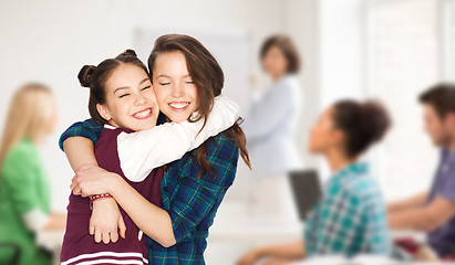 Image showing happy teenage student girls hugging at school