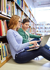 Image showing happy students with laptop in library