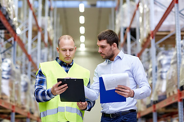 Image showing worker and businessmen with clipboard at warehouse