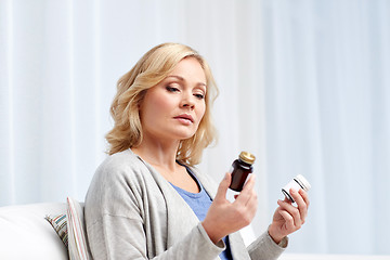 Image showing woman with medicine jars at home