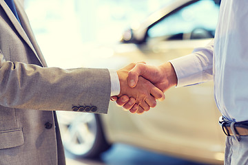 Image showing close up of male handshake in auto show or salon