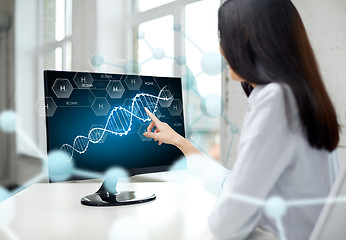 Image showing close up of woman with dna molecule on computer