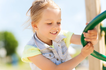 Image showing happy little girl climbing on children playground