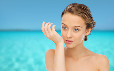 Image showing woman smelling perfume from wrist of her hand