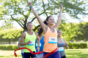 Image showing happy young female runner winning on race finish