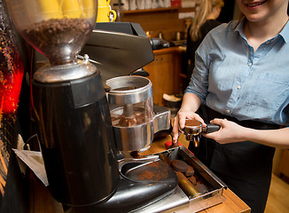 Image showing close up of woman making coffee by machine at cafe