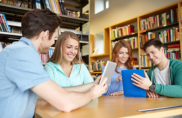 Image showing happy students with tablet pc in library