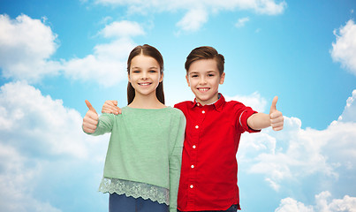 Image showing happy boy and girl showing thumbs up
