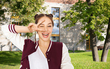 Image showing happy smiling teenage girl showing peace sign