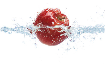 Image showing apple falling or dipping in water with splash