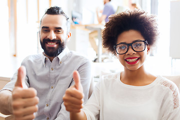 Image showing happy creative team in office showing thumbs up